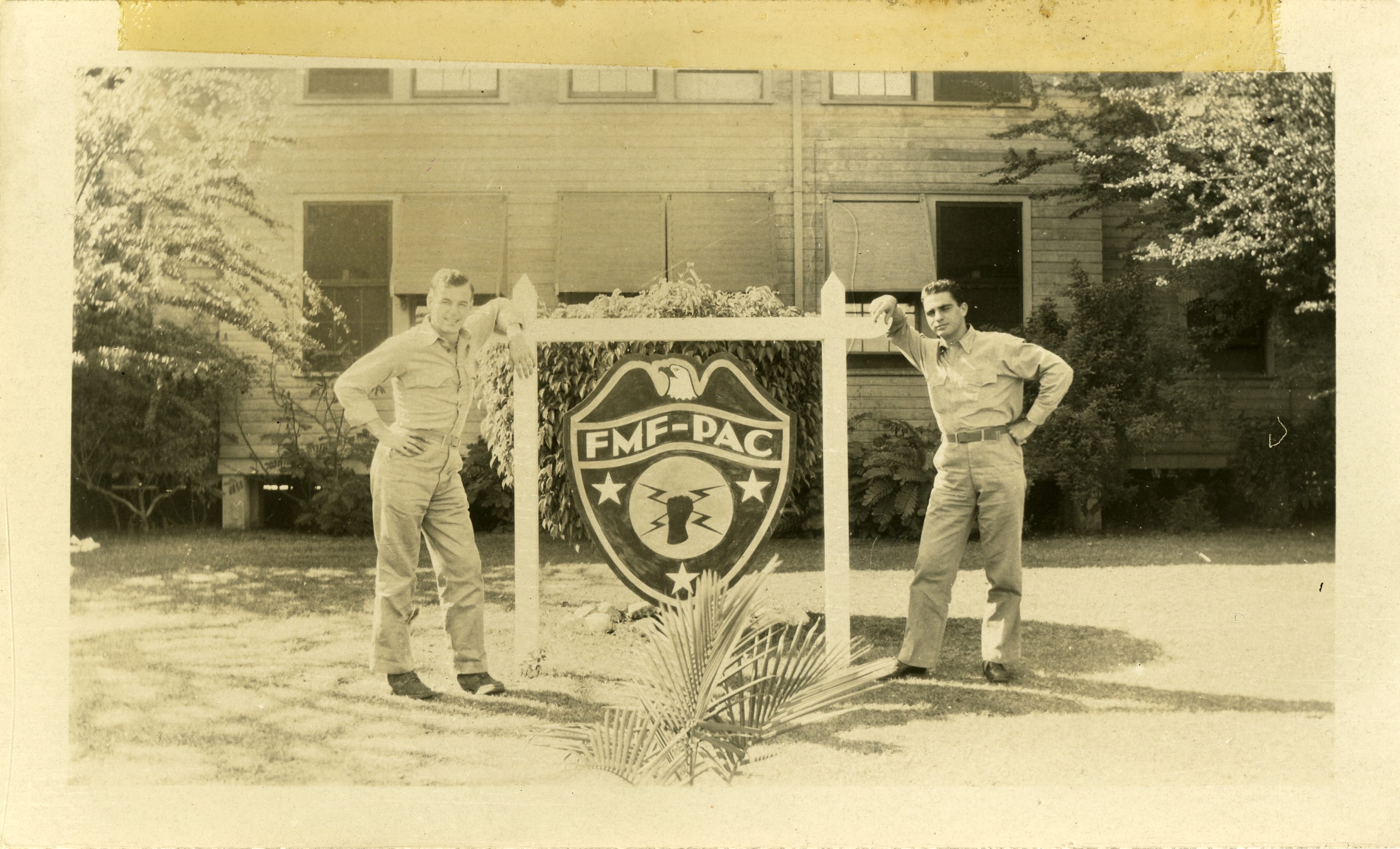 Marines pose with the hanging Fleet Marine Force painted shield sign ...