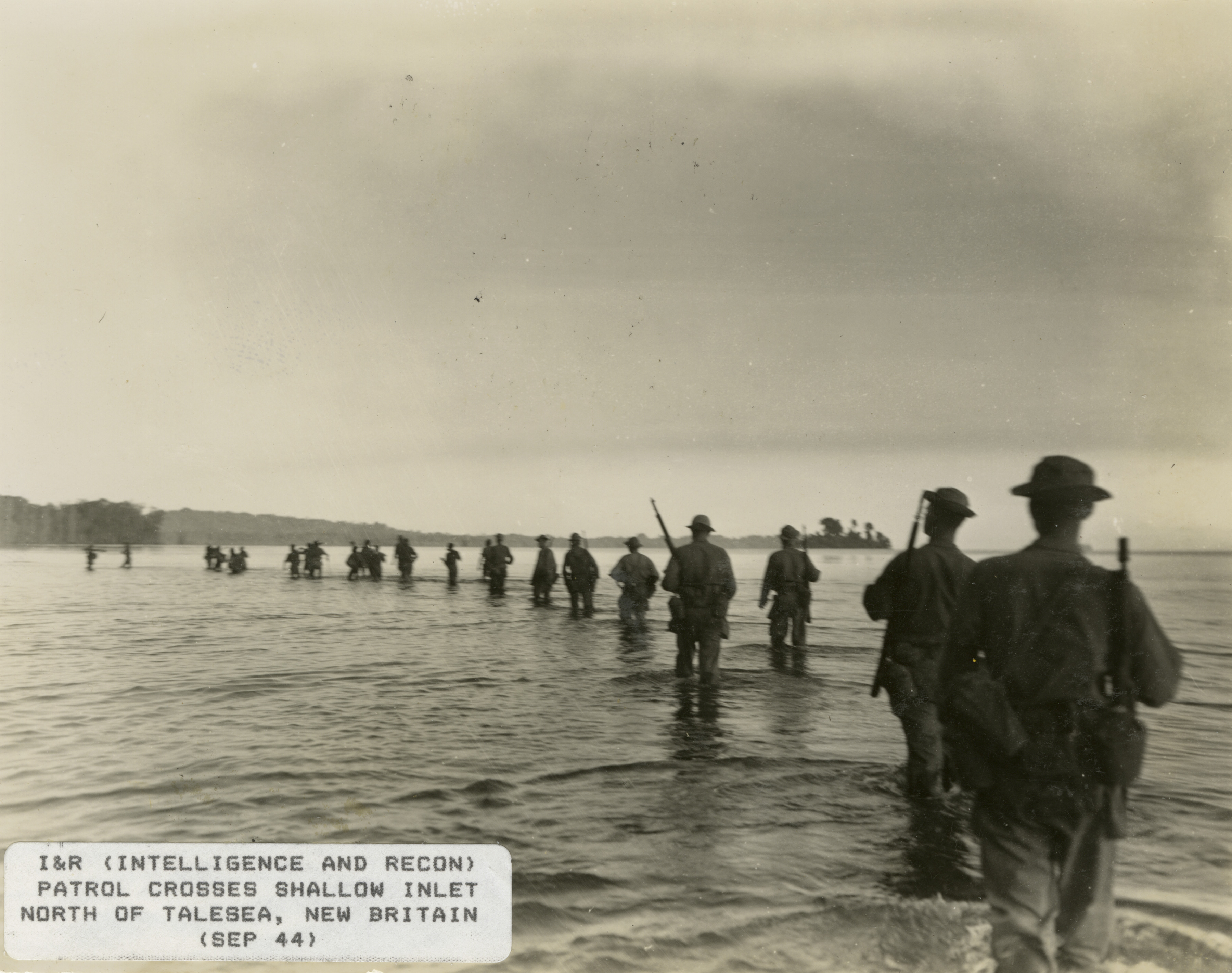 Soldiers Cross A Shallow Body Of Water In A Single File Line At Talasea 