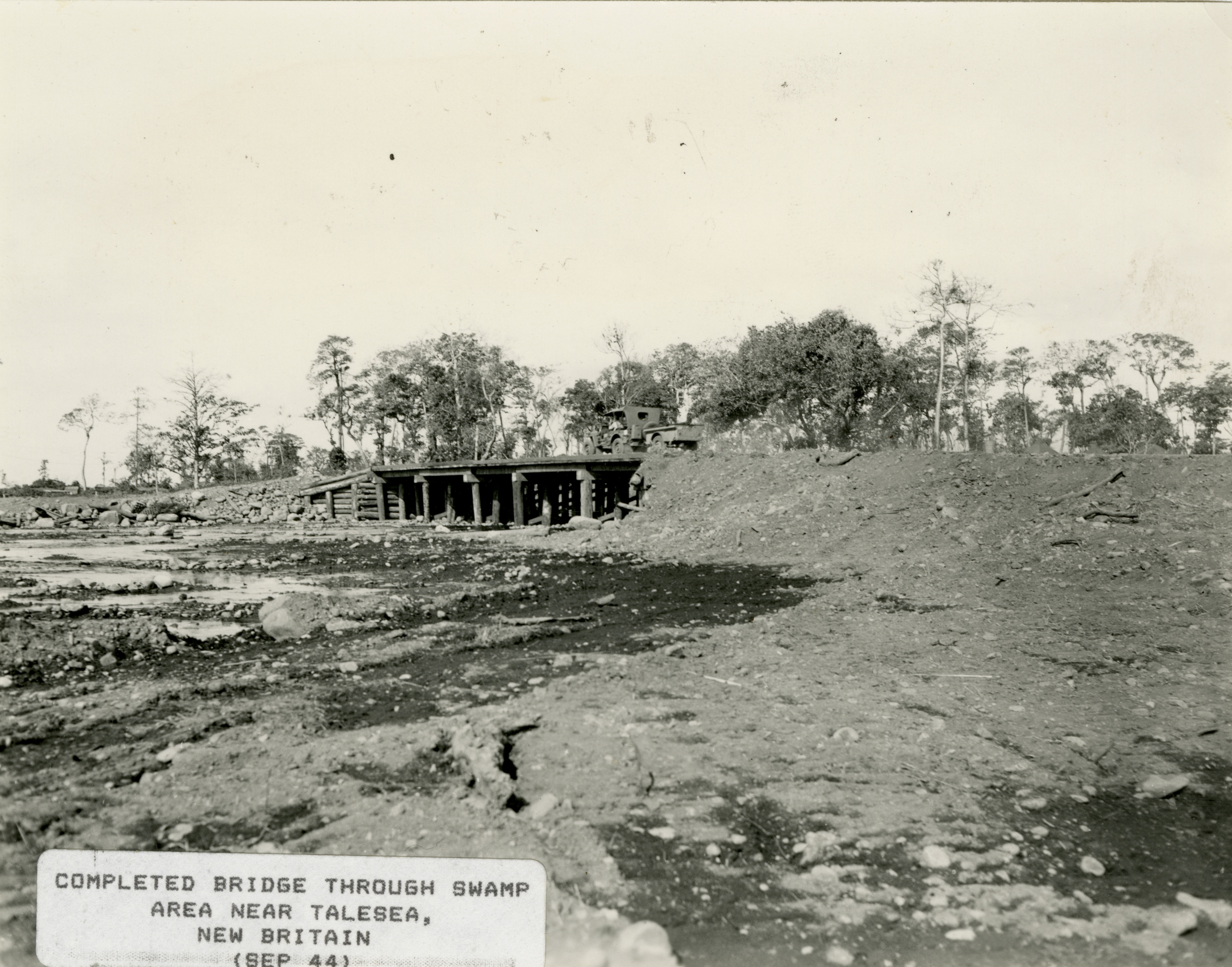 A Tractor Drives Over A Wooden Bridge At Talasea New Britain In 