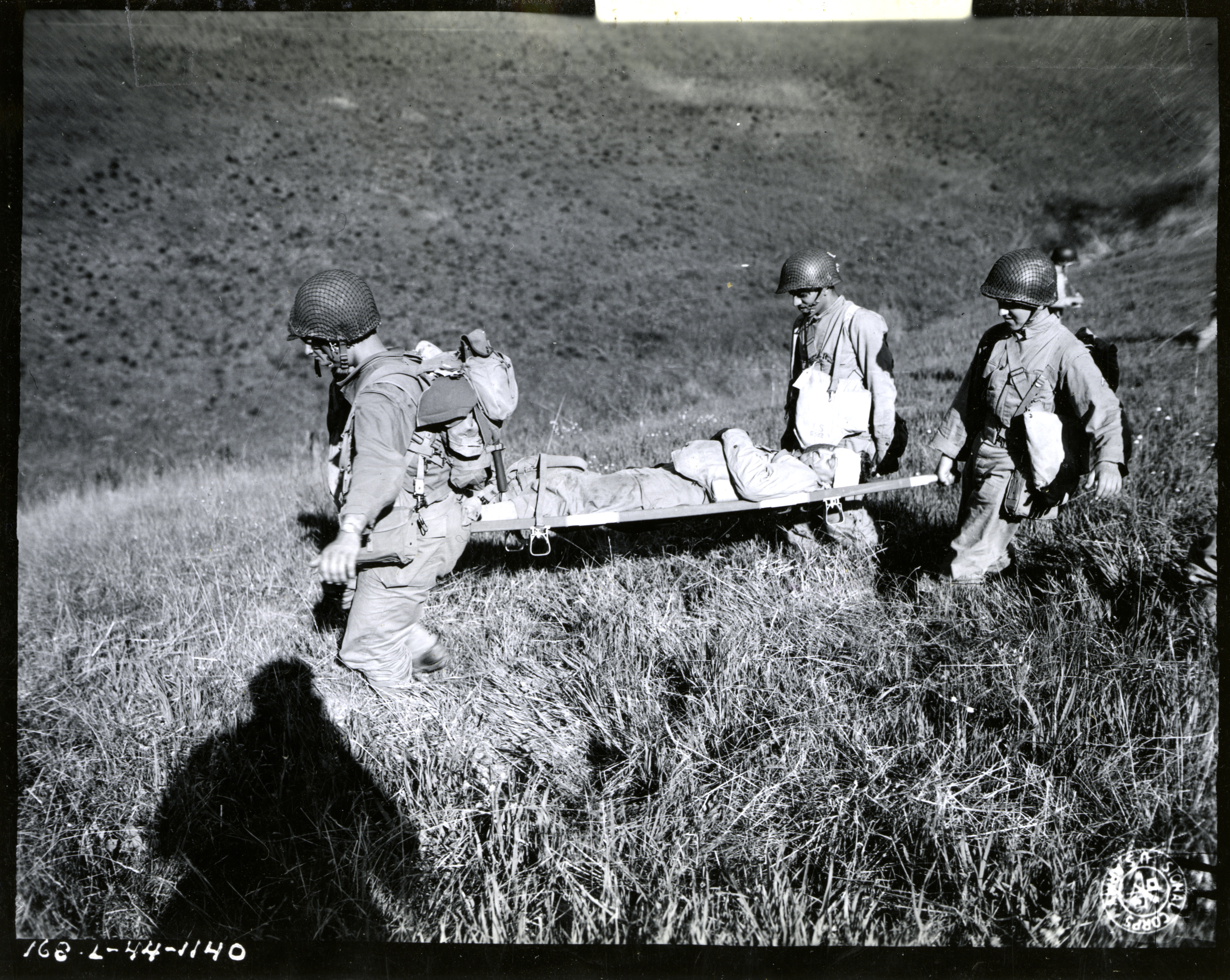 wounded-soldier-being-carried-from-battle-zone-during-maneuvers-near