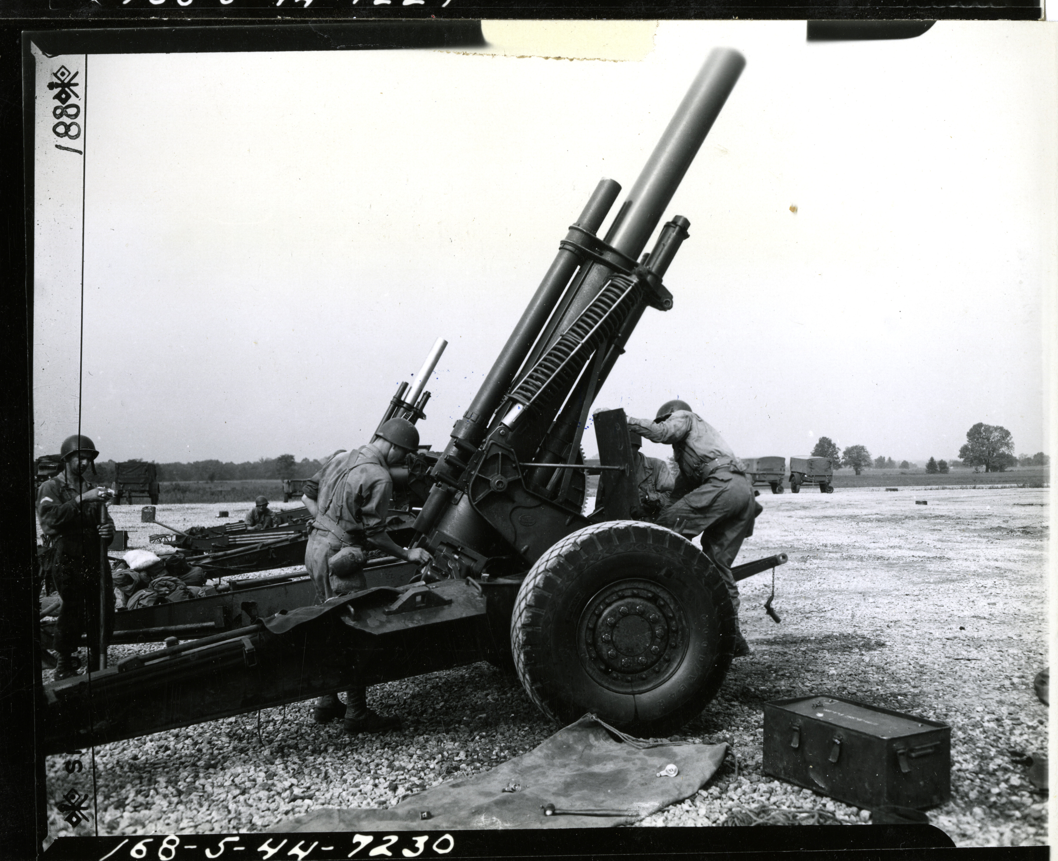 Cleaning and removing the breach block of a 155mm Howitzer after firing ...