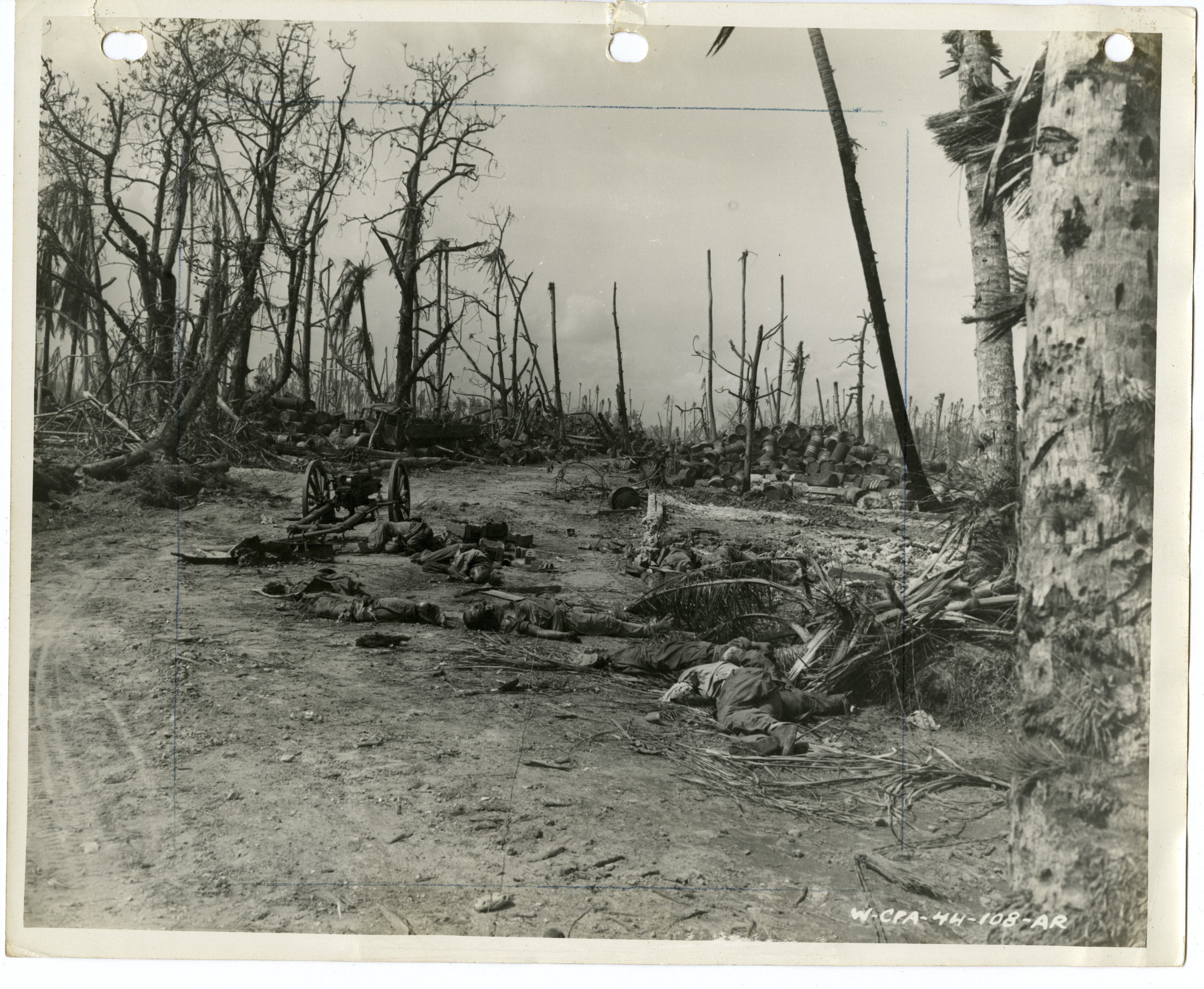 Dead Japanese soldiers strewn about road near a Japanese antitank gun on Kwajalein in February ...