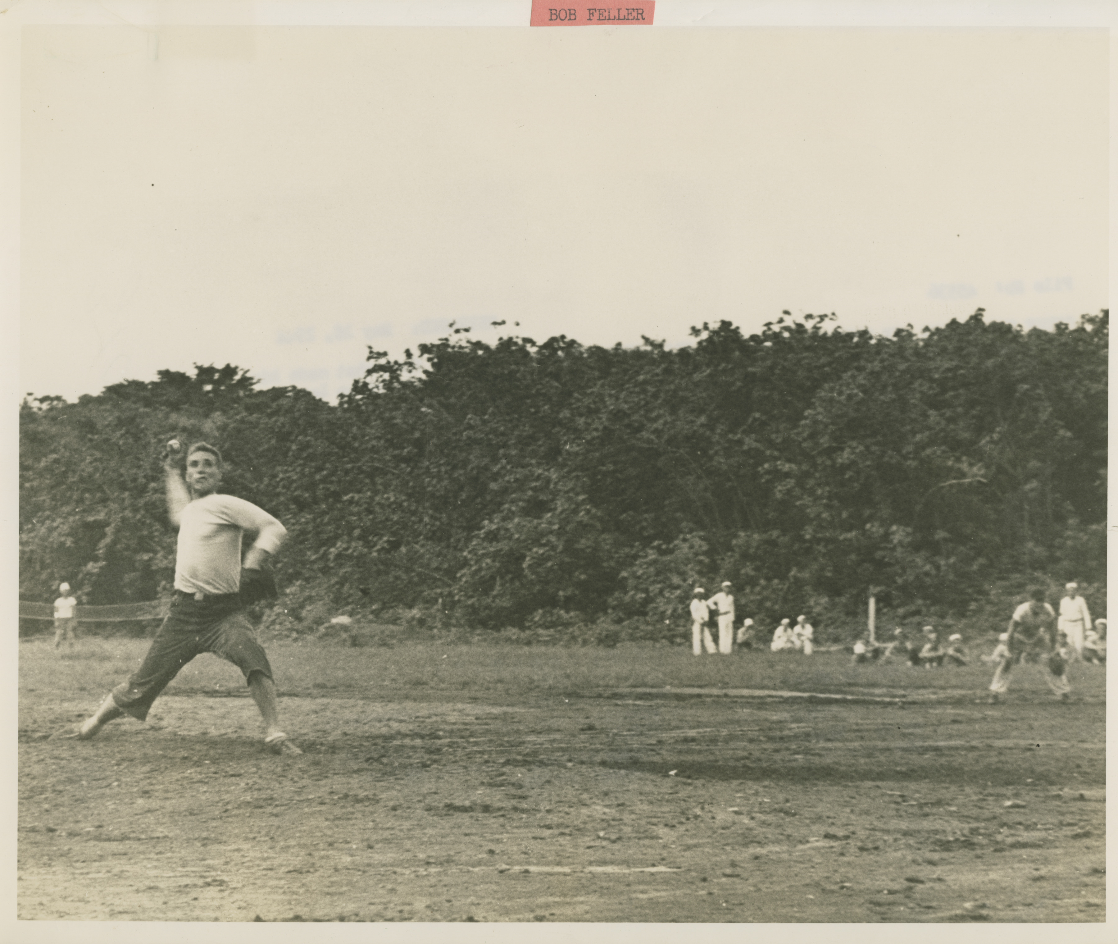 Bob Feller, former Cleveland Indian great, blasts a strike past an opposing  batter during a game in which he struck out 18 men at Efate in the New  Hebrides in 16 May
