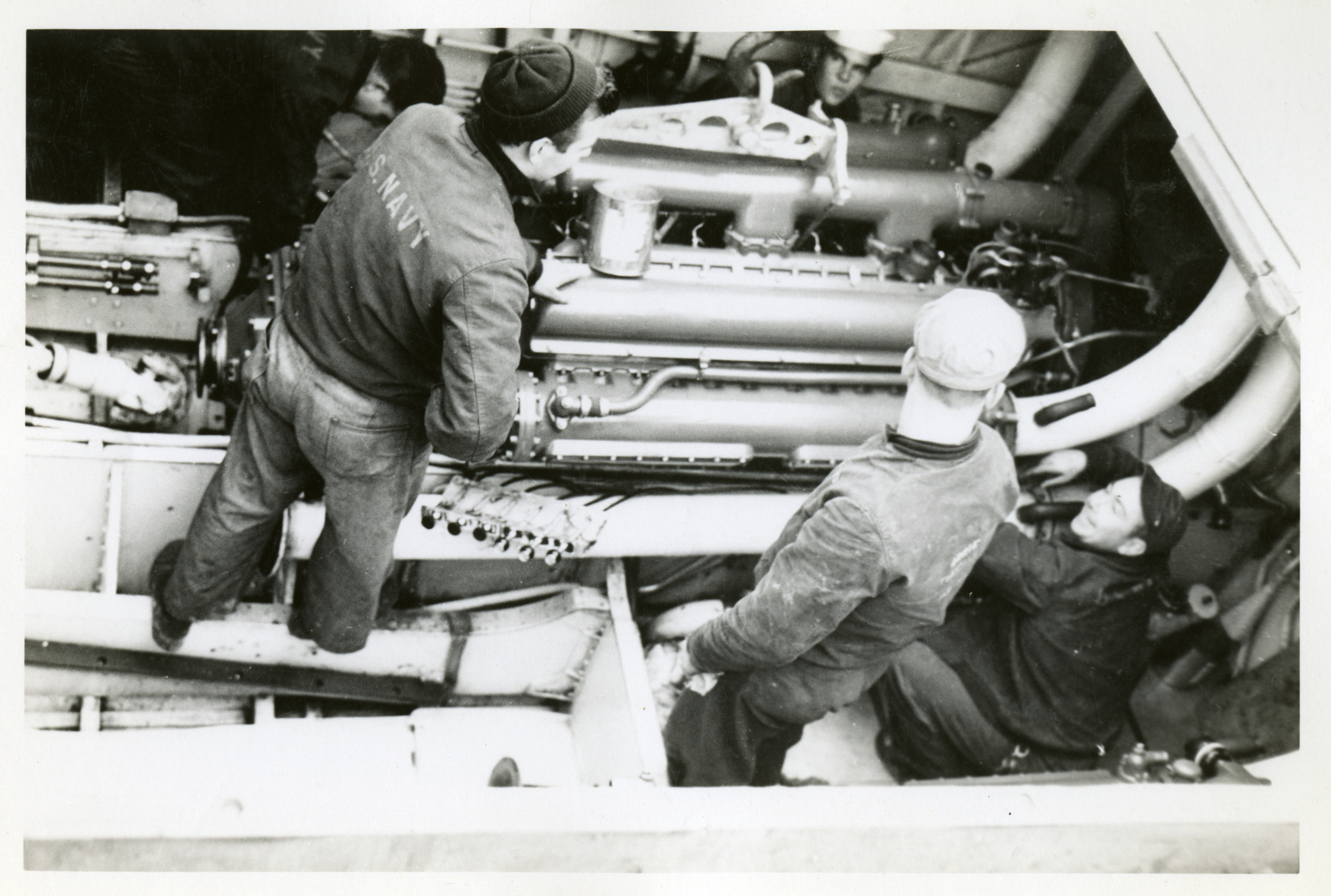 U.S. sailors working on PT boat engine in England or France, circa 1944