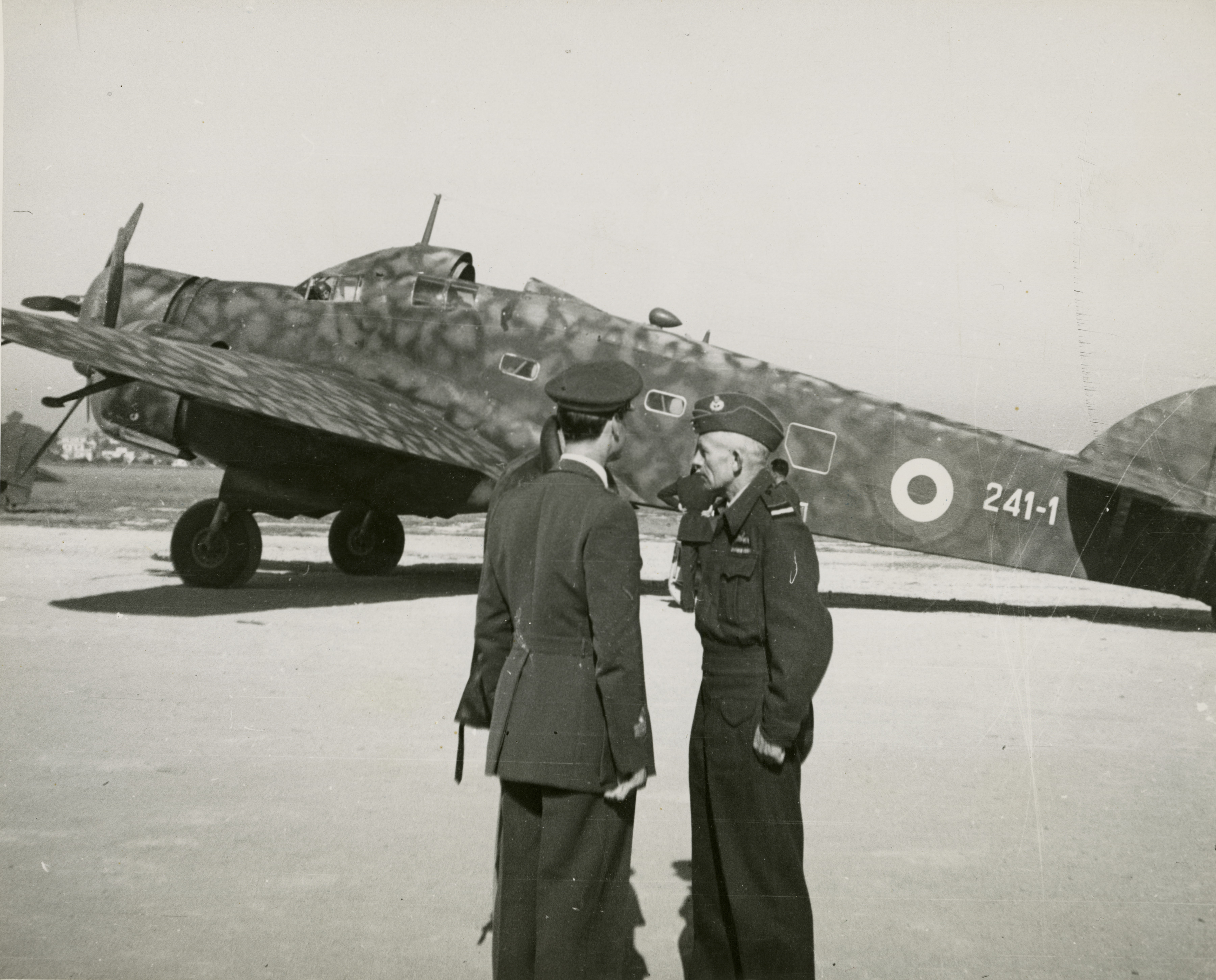 Marshal I.E. Brodie Royal Air Force speaking with Italian pilots