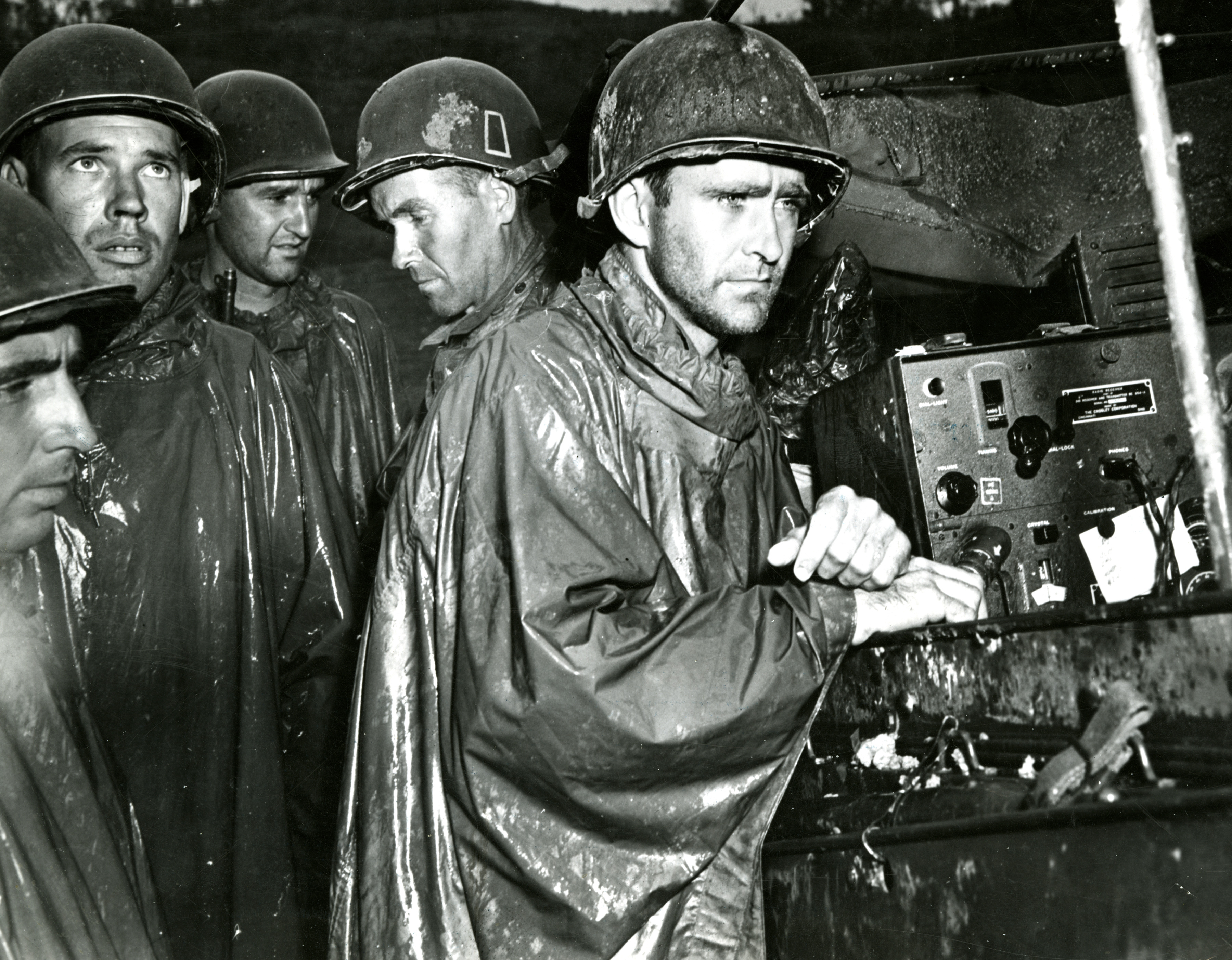 Men Of The 77th Infantry Division Listen To Radio Reports Of Germany s 