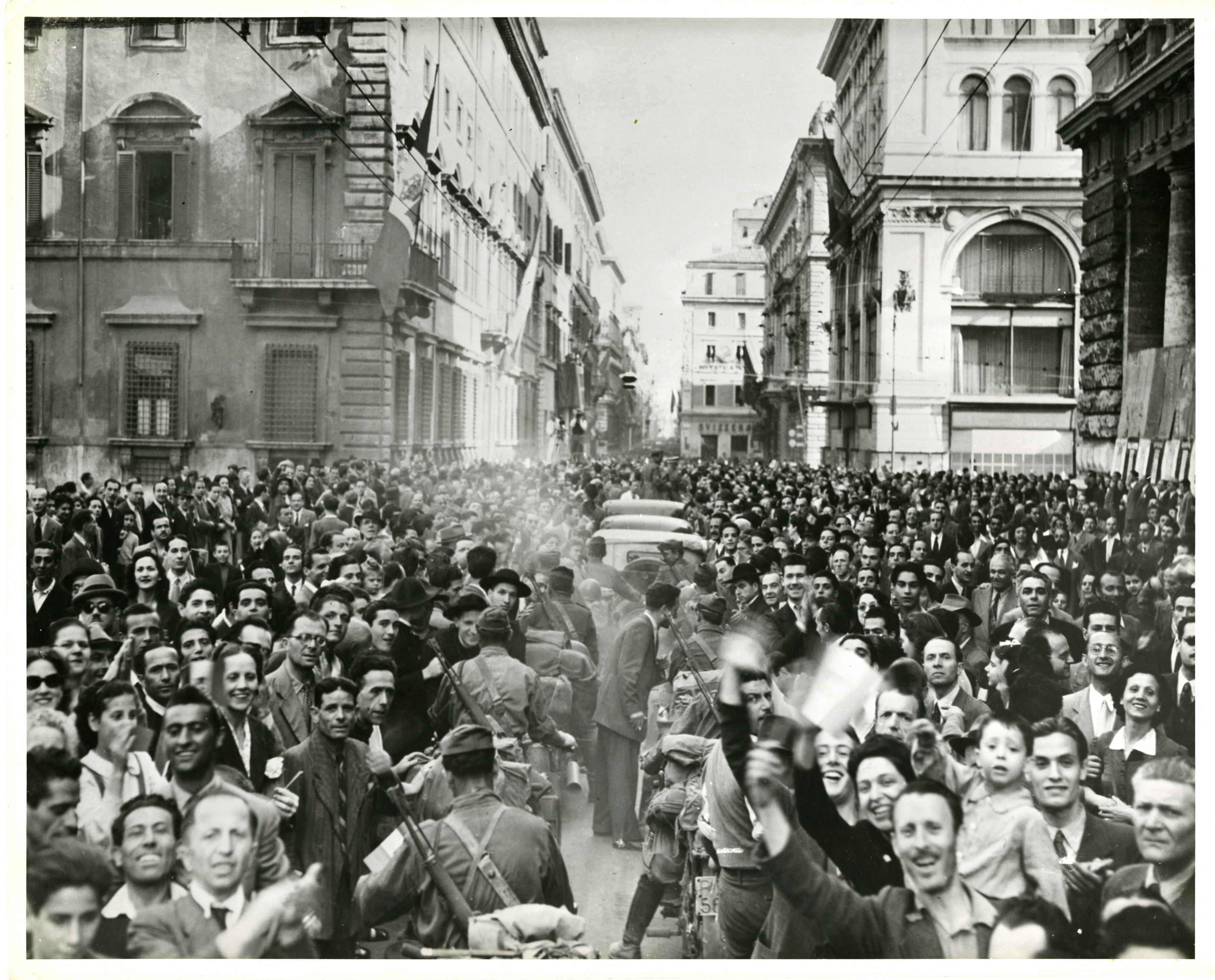 Large crowd of people celebrate in the street, ETO, 1945 | The Digital ...