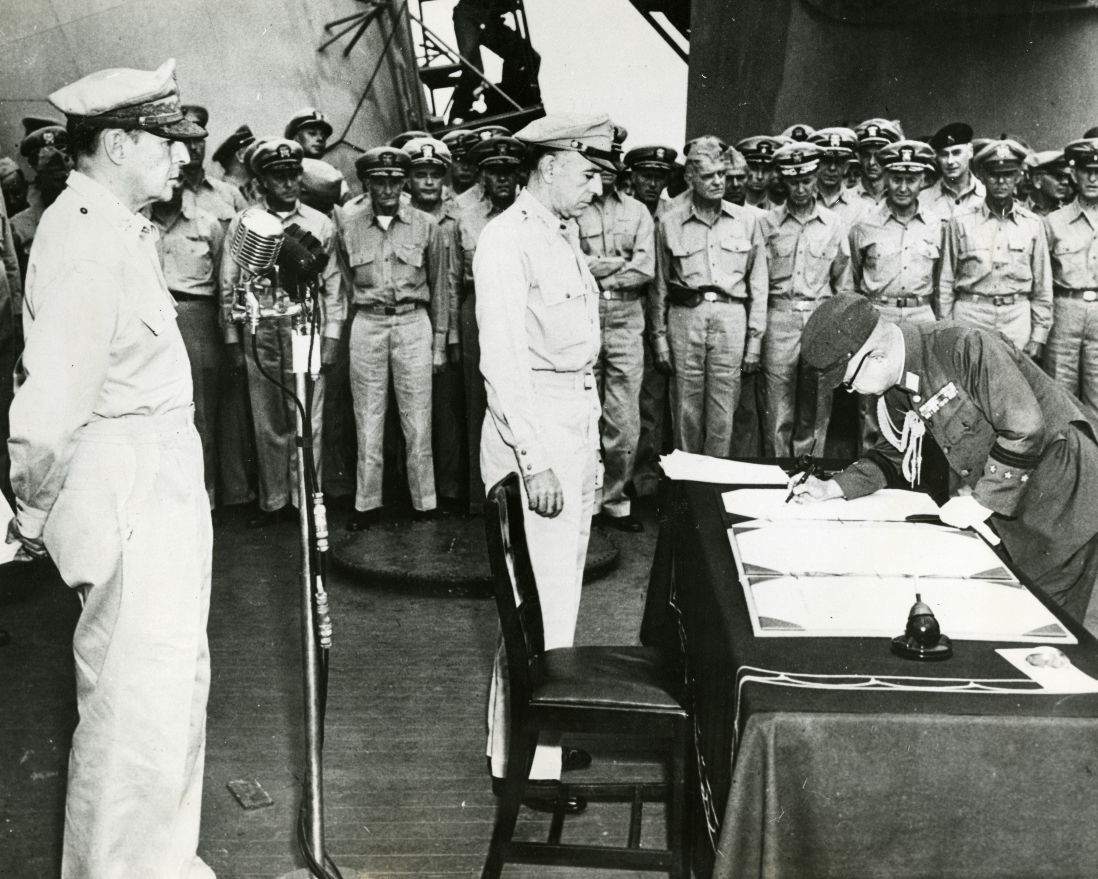 Japanese General Yoshijirō Umezu signing surrender documents on the U.S ...