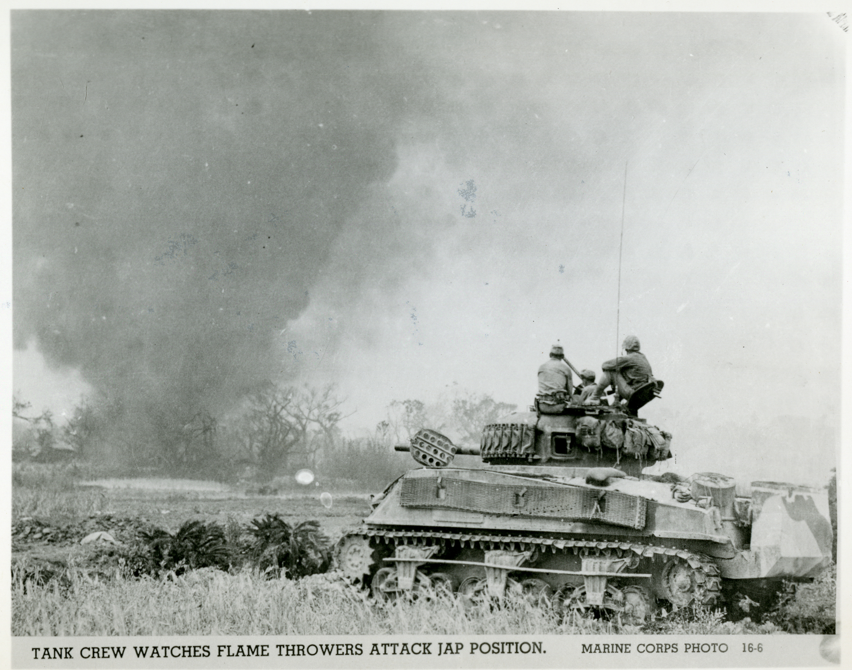 US tank crew watching flamethrowers attacking Okinawaese troops, Okinawa,  1945